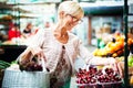 Picture of mature woman at marketplace buying vegetables Royalty Free Stock Photo