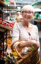 Picture of mature woman at marketplace buying vegetables Royalty Free Stock Photo