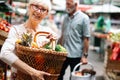 Picture of mature woman at marketplace buying vegetables Royalty Free Stock Photo