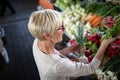 Picture of mature woman at marketplace buying vegetables Royalty Free Stock Photo