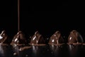 picture of melting dripping chocolate drops on black background generative AI