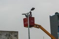 This is a picture of men working on an electrical pole