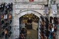 Turkish salesman resting and checking his smartphone in his shop, selling shoes and boots, in the Beyazit district