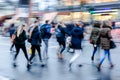 Wintry street scene in the city with people crossing a street Royalty Free Stock Photo