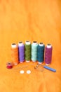 Picture of multicolored sewing thread, needle, bobbin, button, safety pin and needle ripper Royalty Free Stock Photo