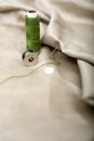 Picture of needle attached in cloth with green Sewing thread and bobbin Royalty Free Stock Photo