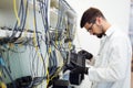 Picture of network technician testing modems in factory Royalty Free Stock Photo