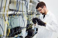 Picture of network technician testing modems in factory Royalty Free Stock Photo