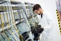 Picture of network technician testing modems in factory