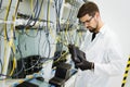 Picture of network technician testing modems in factory Royalty Free Stock Photo