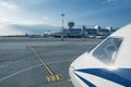 The nose of an airplane with the Minsk airport in the distance