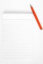 Picture of notepad with orange pen Royalty Free Stock Photo