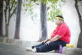 Obese man looks pensive after exercise in the park