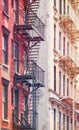 Picture of old buildings with fire escapes, color toning applied, New York City, USA Royalty Free Stock Photo
