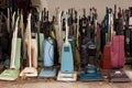 Picture of old handheld vacuum cleaners covered in dust surrounded by dry leaves