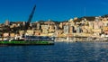 Old port of Genova city with cargo boats with crane at coast line