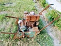 A picture of old and rusted grass cutting machine