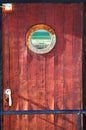 Picture of old ship door with a round window Royalty Free Stock Photo