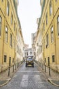 Old vintage car driving down a cobblestone street Royalty Free Stock Photo