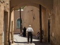 Iranian seniors, one old man and one old woman, walking in one of the streets of the old town of Yazd