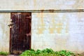 Old wood door near a concrete wall Royalty Free Stock Photo