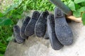 Picture of a 3 pair of rubber boots in the garden