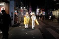 COLOGNE, GERMANY - NOVEMBER 11, 2022: Selective blur on a group of two men, friends, german men dressed with white costumes for