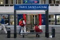 Passengers rushing near a suburban train on a platform of Gare Saint Lazare train station.