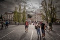 Picture of people walking on Tromostovje bridge triple bridge between Presernov square and the older part of Ljubljana Royalty Free Stock Photo