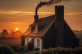 picture-perfect sunset, with the sun sinking behind a rooftop and chimneystack in the countryside Royalty Free Stock Photo