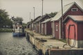 Picture of pier with boat in scandinavian fishing village Royalty Free Stock Photo