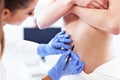 Plastic surgeon making marks on patient`s body Royalty Free Stock Photo