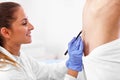 Plastic surgeon making marks on patient`s body Royalty Free Stock Photo