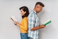 Happy smiling adult loving couple isolated over grey wall background reading books
