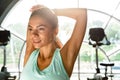 Picture of Pleased sports woman warming up and looking away