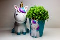 Porcelain unicorn figurine and vase of same shape on white background Royalty Free Stock Photo