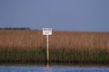 Picture of a posted sign in the marsh in South louisiana.