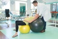 picture pregnant woman exercising with ball helped by physiotherapist Royalty Free Stock Photo