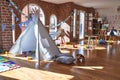 Picture of preschool playroom with colorful furniture and toys around empty kindergarten