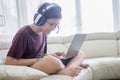 Preteen boy playing a laptop on the sofa Royalty Free Stock Photo