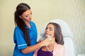 Picture of pretty beautician doing microdermabrasion procedure f
