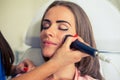 Picture of pretty beautician doing microdermabrasion procedure f