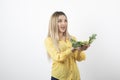 Picture of a pretty woman model standing and holding cauliflower in hand