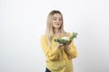 Picture of a pretty woman model standing and looking at cauliflower
