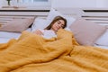 Picture of a pretty, young lady smiling in sleep, in a bed, indoors. Royalty Free Stock Photo