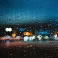 Picture Raindrops on glass window against blurred city lights background Royalty Free Stock Photo