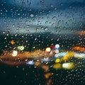 Picture Raindrops on glass window against blurred city lights background Royalty Free Stock Photo