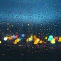 Picture Raindrops on glass window against blurred city lights background Royalty Free Stock Photo