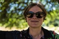 Picture of a relaxed attractive woman in the shadows of a tree