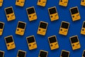 Picture of retro yellow game console pattern on blue background